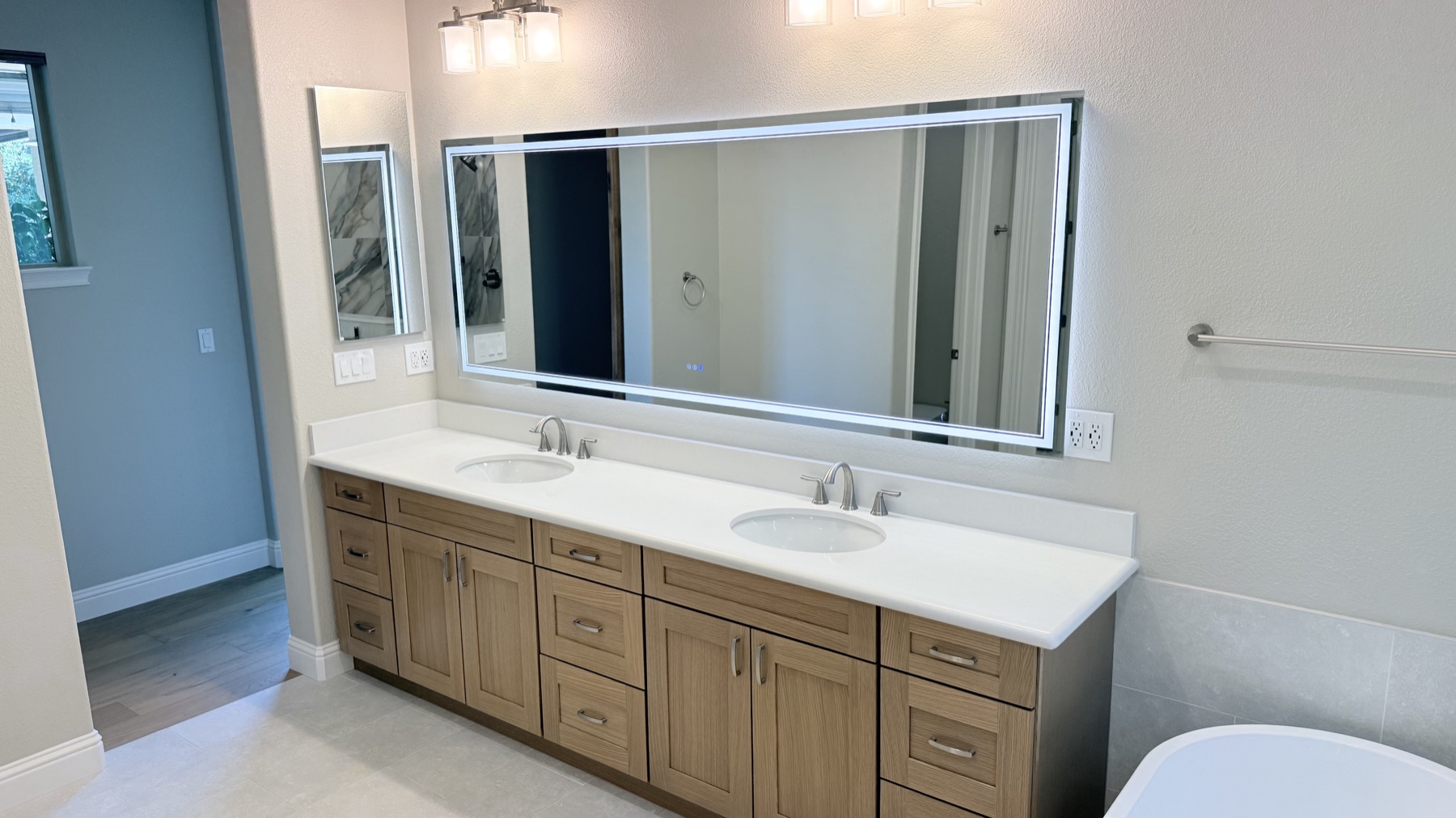 New double vanity and illuminated mirror in an El Dorado Hills primary bathroom