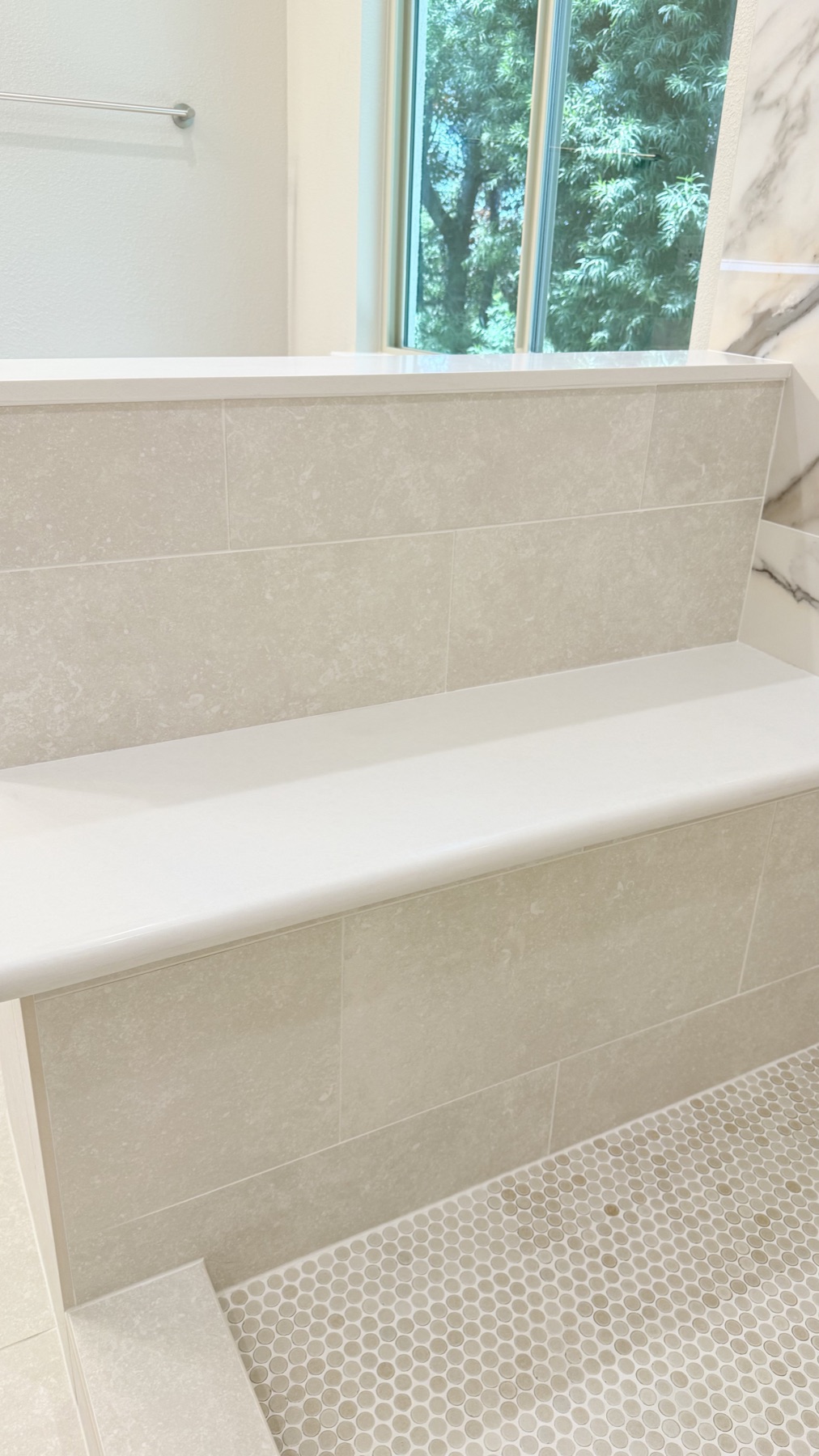 Built-in shower bench with neutral tile in an El Dorado Hills bathroom remodel