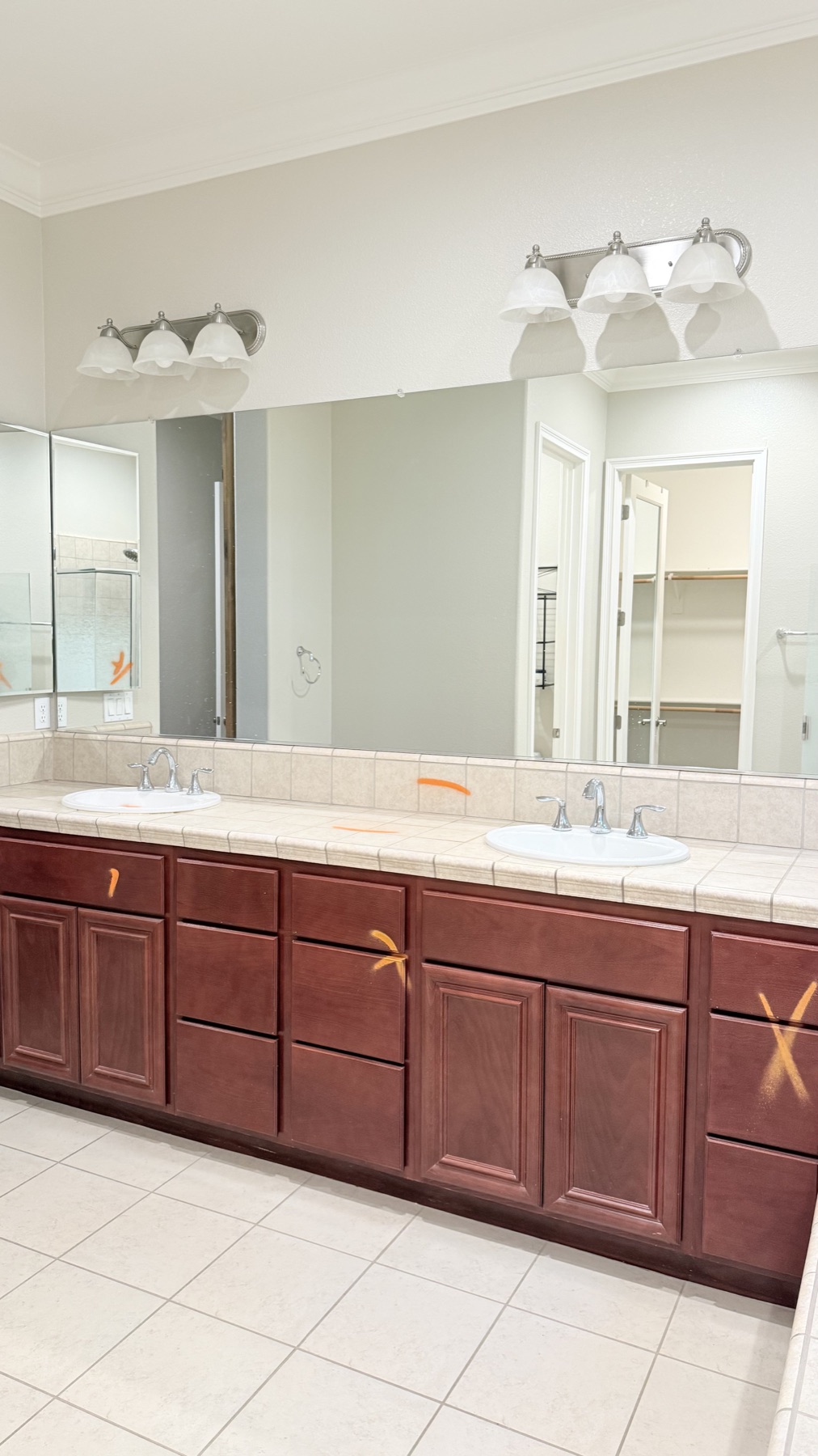 Original double vanity with dark wood cabinets and tile countertops before remodeling in El Dorado Hills