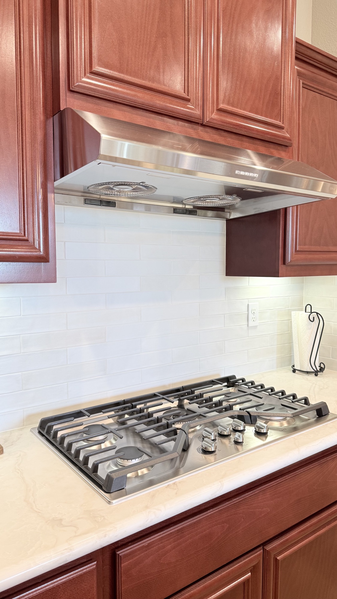 Stainless steel range hood and bright backsplash after an El Dorado Hills kitchen remodel
